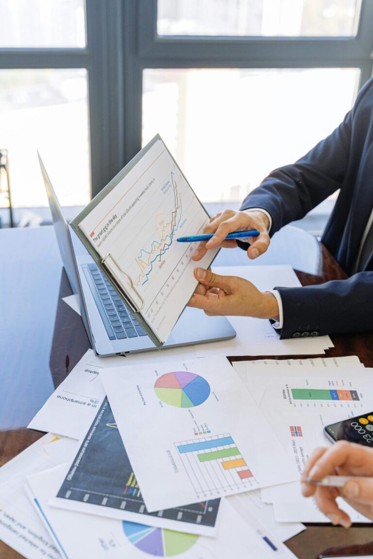 Business team reviewing charts and reports together at a meeting table